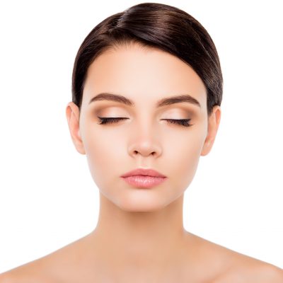 Beautiful girl with closed eyes showing her maquillage